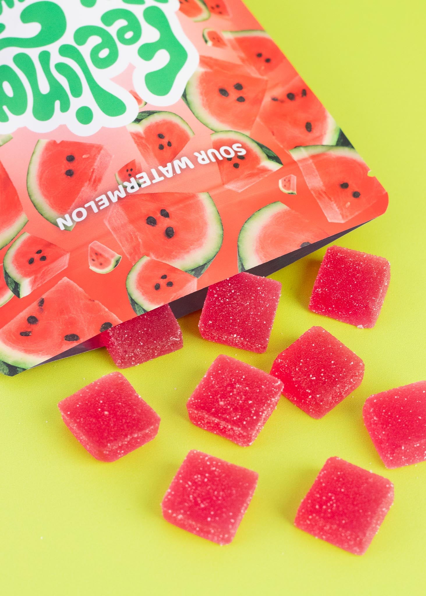 Sour watermelon gummy candies with a watermelon-flavored packaging on a yellow background