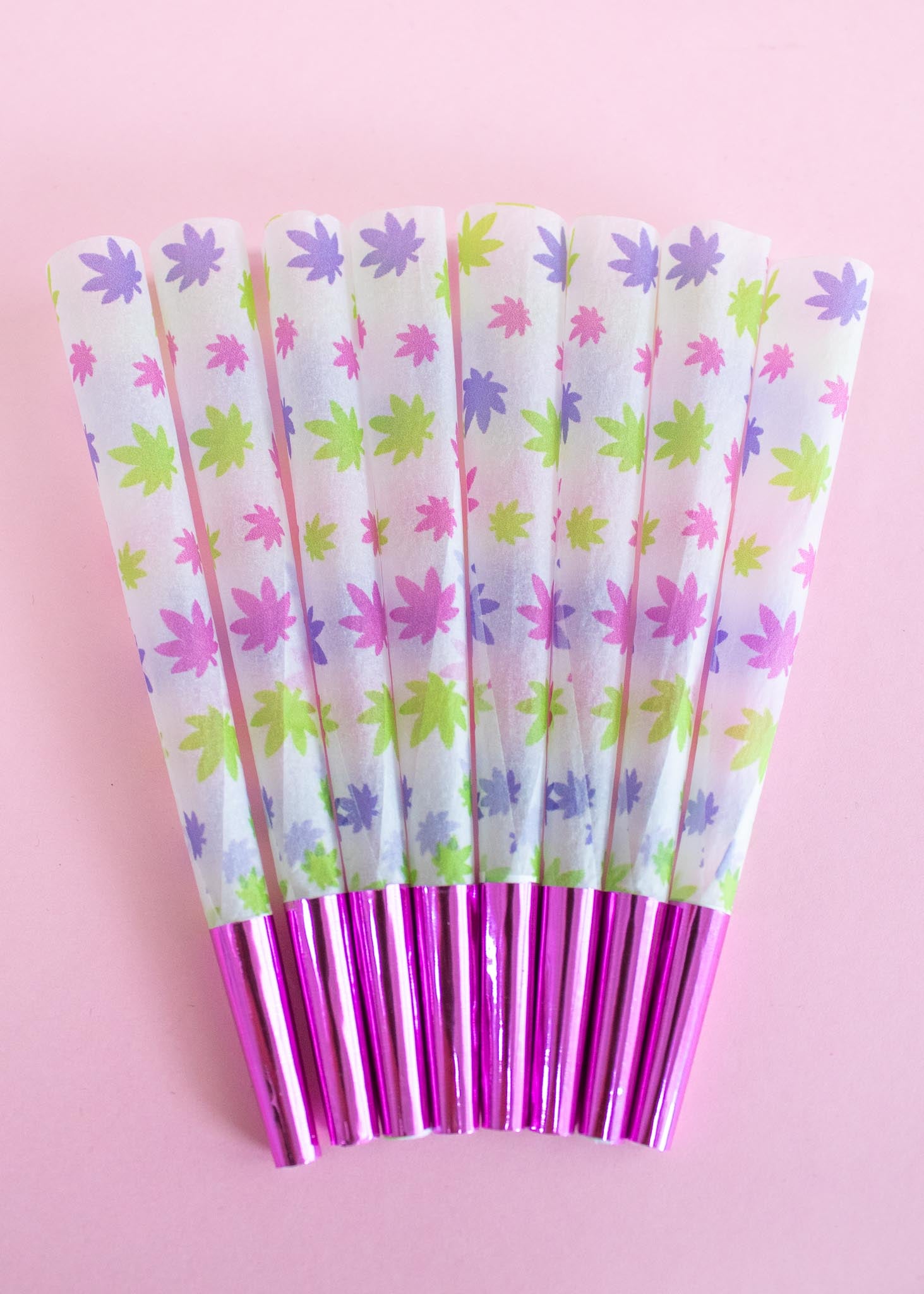 white paper with green, purple, and pink weed leaves